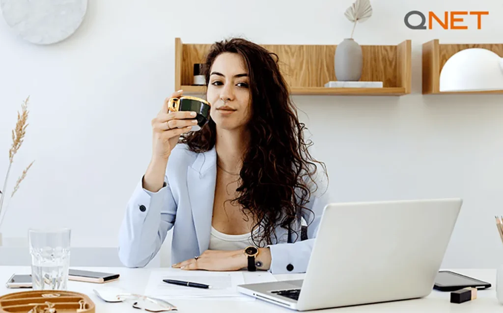 A young businesswoman typing on a laptop in her workplace | Importance of goal setting