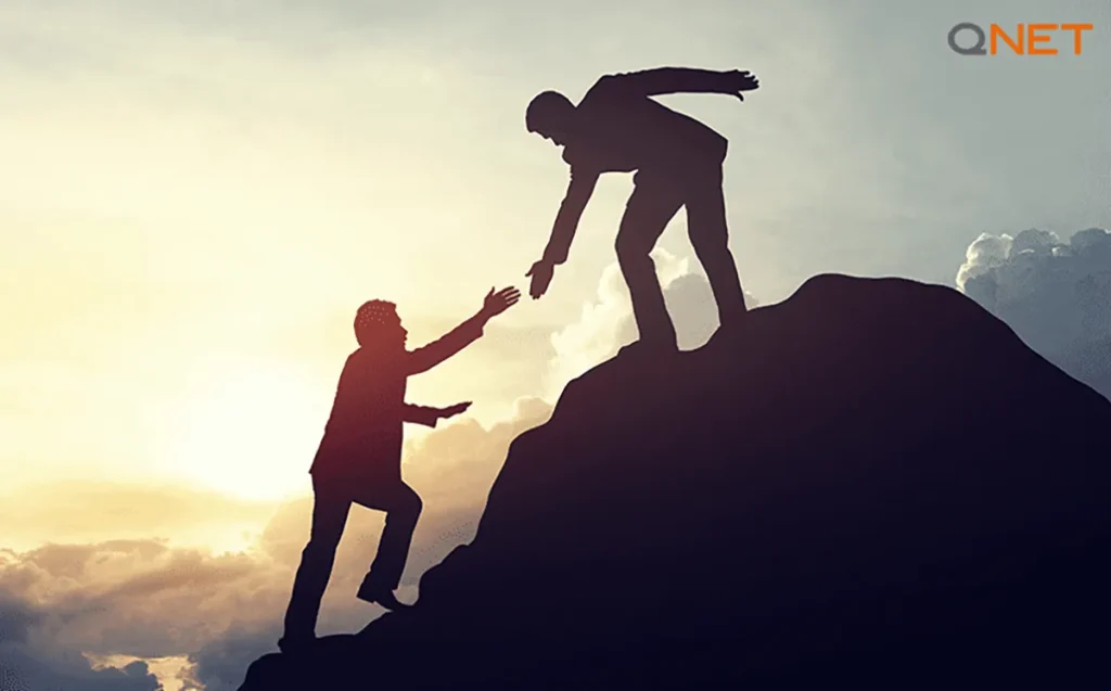 Businessmen helping each other to overcome challenges in business