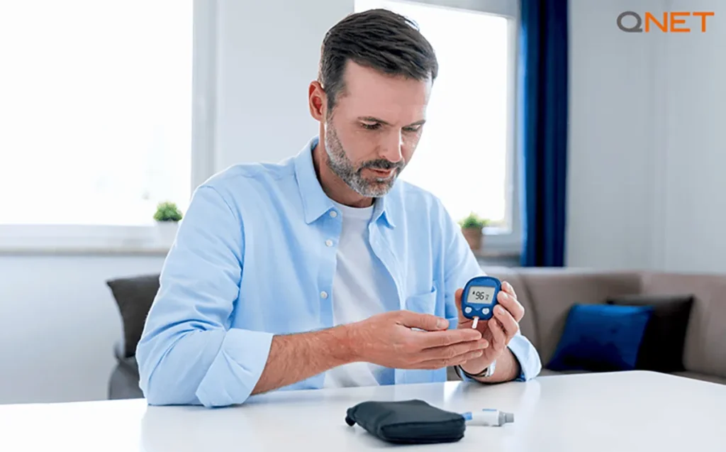 An aged man checking his blood sugar level for diabetes