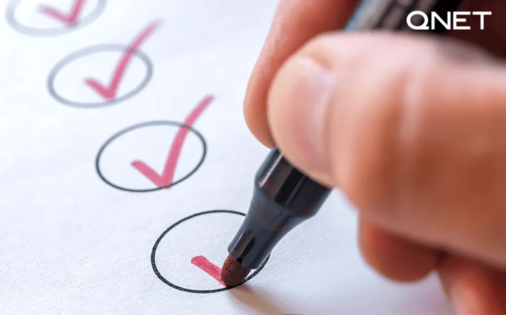 A hand ticking off the to-do checklist | QNET India
