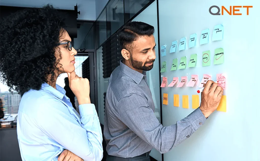 QNET Entrepreneur writing on white board