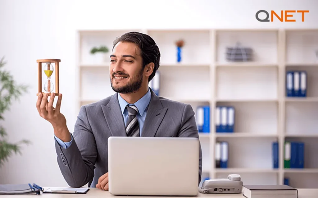 A businessman holding an hourglass