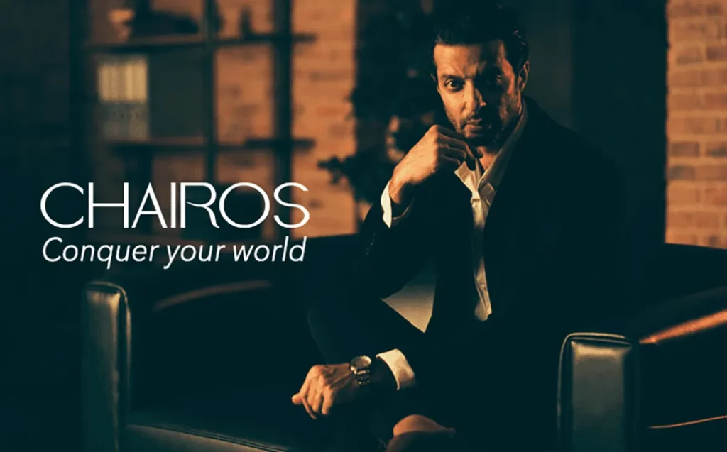 A stylish young man in a suit showcasing his new CHAIROS watch