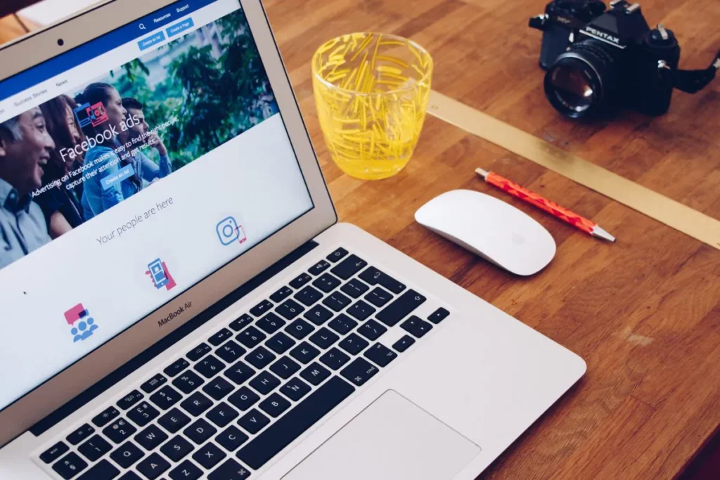 QNET's Social Media Policy: A laptop screen with Facebook Ads