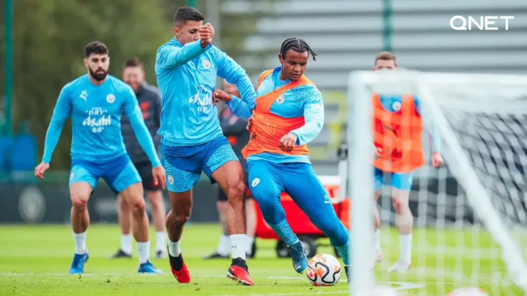 Rodrigo and Manuel Akanji compete for possession